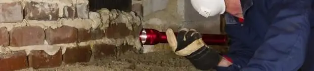 Pest control technician inspecting a crawl space for ant activity and entry points in El Paso, TX