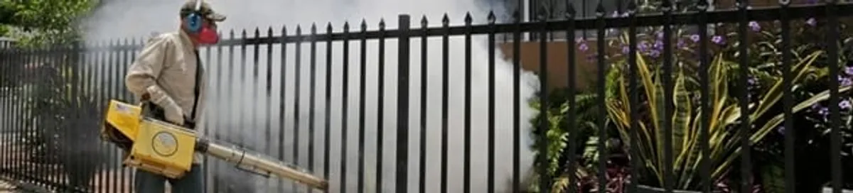 Mosquito control technician fogging a yard perimeter for mosquito reduction in El Paso, TX